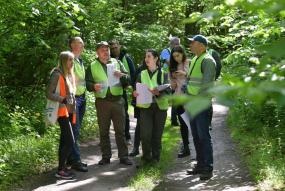 foresters standing together in a group on trail in the forest